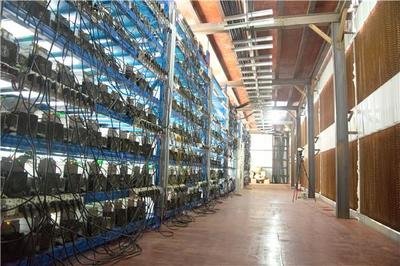 Rows of mining machines working efficiently in a mining farm equipped with cooling systems